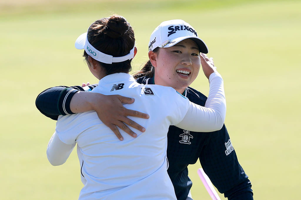 Miyu Yamashita and Rio Takeda embrace following their opening rounds at Royal Porthcawl